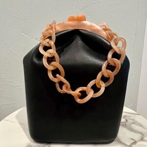 Urban Expressions Black vegan leather bucket bag with resin accents.